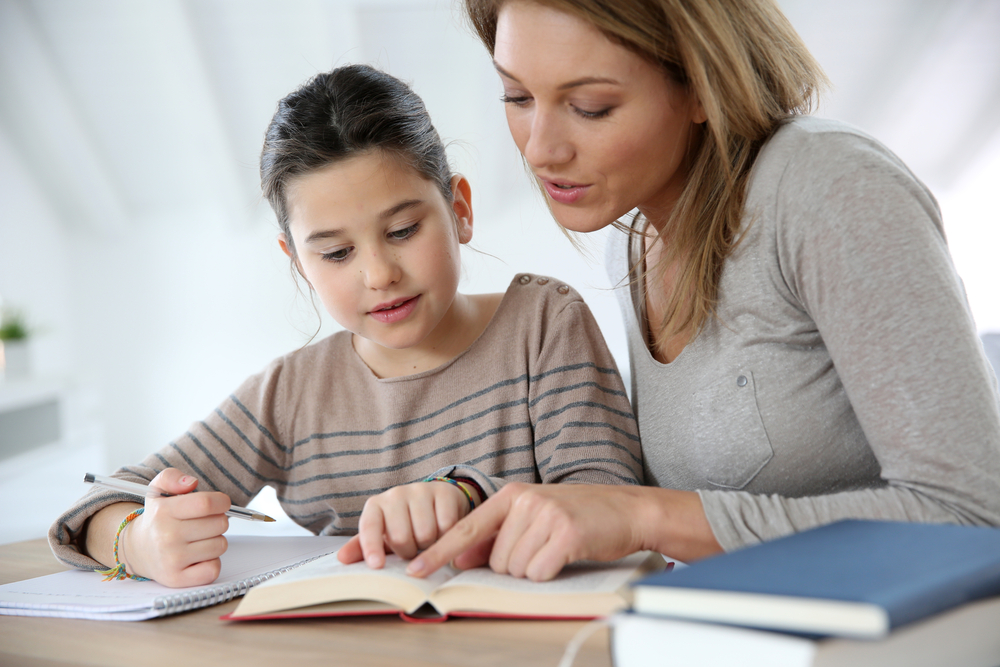 Mom helping kid with homework Mom helping kid with homework